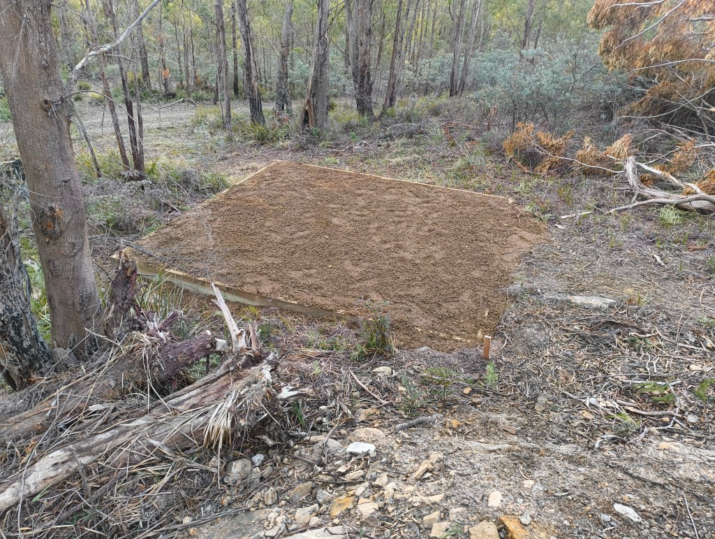 A cleared level patch of ground prepared for the water tank.