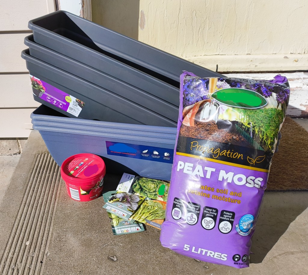 The materials used to make my small pot-based garden, a bag of peat moss, seeds, slow-release fertiliser and planters.